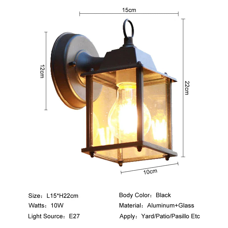 Udendørs væglampe i sort aluminium og glas, E27 fatning, 10W, ideel til gårdhave eller terrasse. Mål: 15x22 cm. Elegant belysning til udendørs brug.