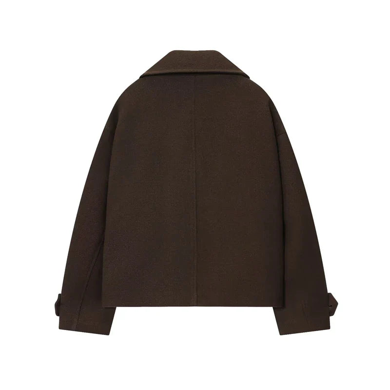 Brun uldjakke til kvinder set bagfra, minimalistisk design, brede skuldre, lange ærmer med stropdetaljer, perfekt til efterår og vintermode.