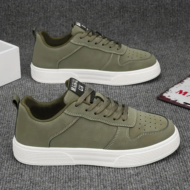 Grønne sneakers til mænd med hvid sål, snørebånd og perforeret tådesign. Moderne herresko til casual brug.