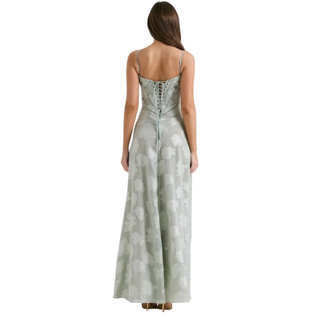 Woman wearing a light green Kouvr floral dress on a white background
