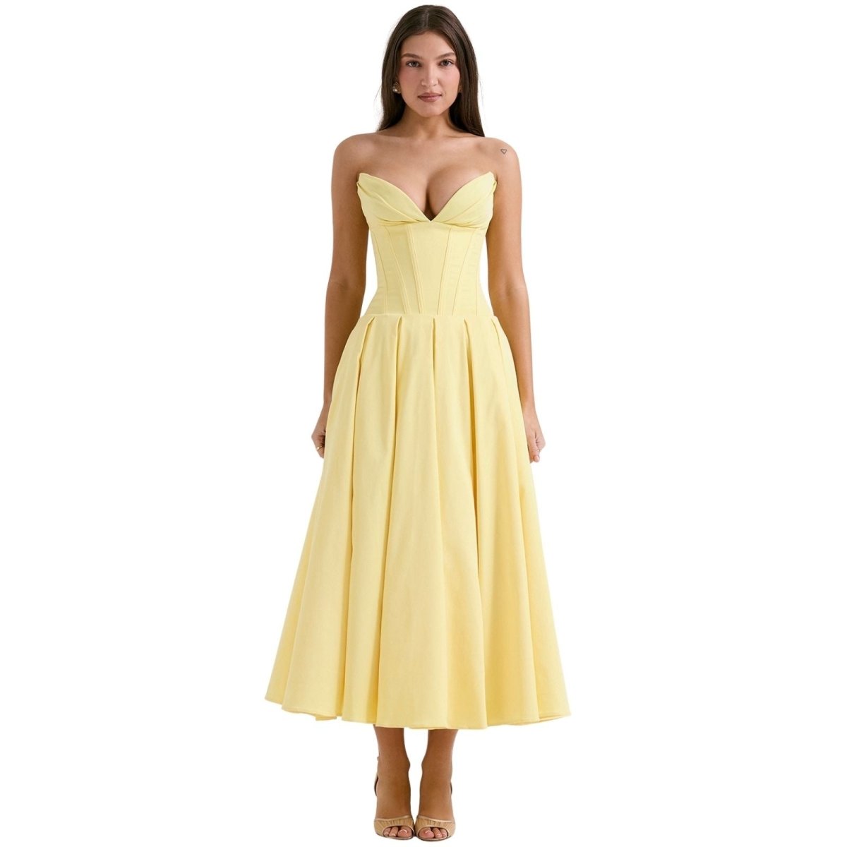 Woman wearing a yellow strapless dress on a white background