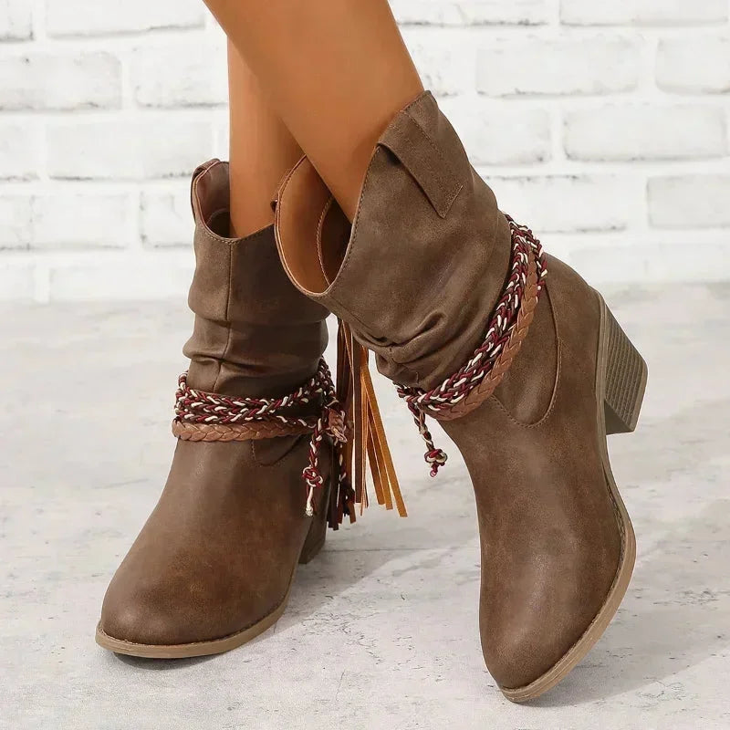 Dark brown western slouchy boots with braided tassels and stacked heel.