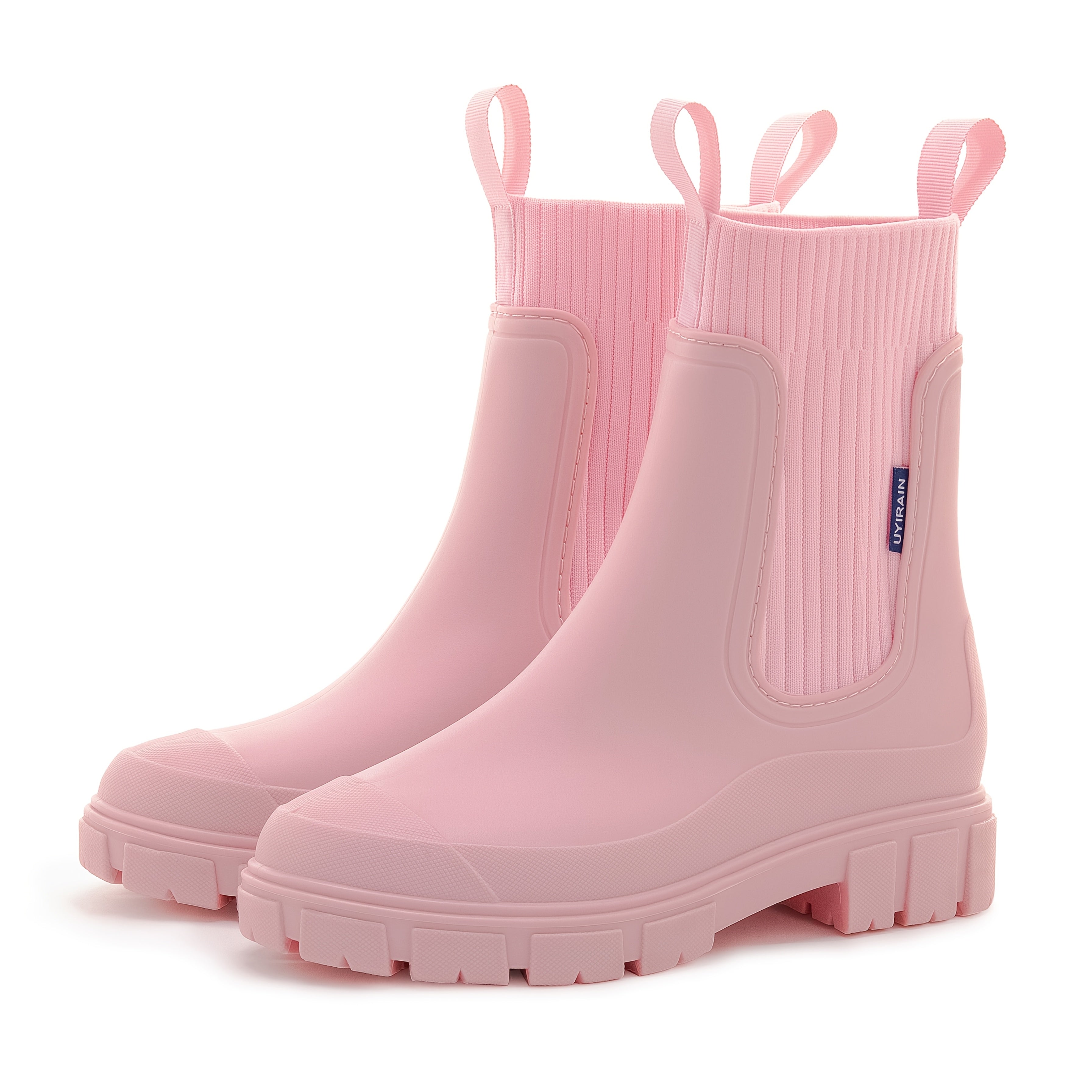 Lyserøde gummistøvler med ribbet skaft og kraftig sål. Moderne design, velegnet til regnvejr. Perfekt til modebevidste kvinder.