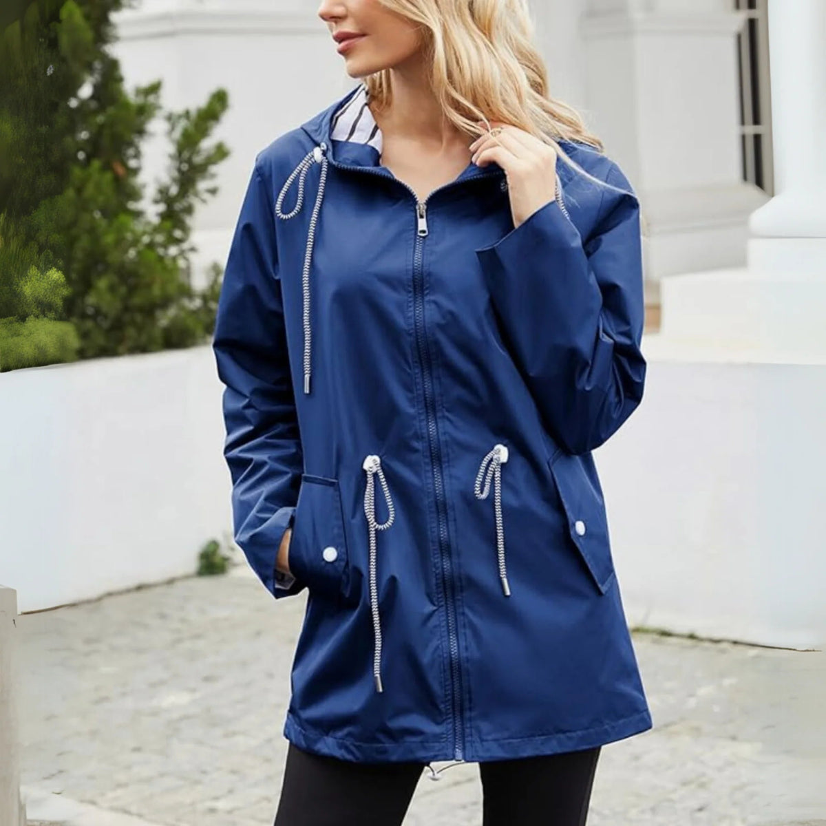 Women's waterproof hooded denim jacket with striped lining & drawstring waist.